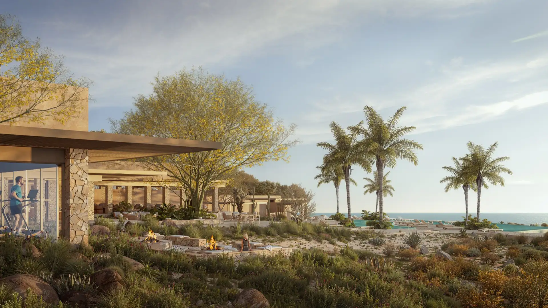 A desert-landscaped terrace with fire pits and an open-air fitness pavilion, palm trees leading to an infinity pool along the Sea of Cortés.