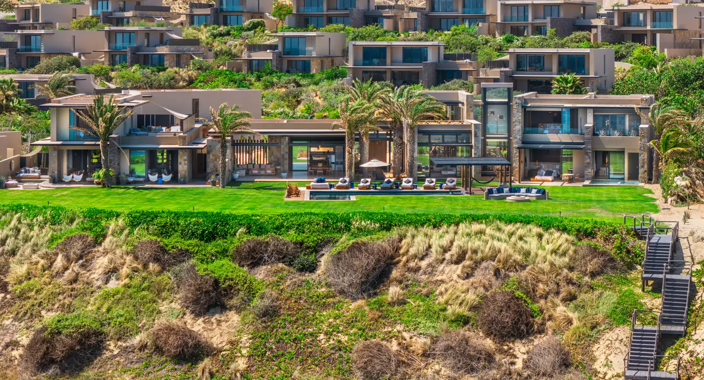 Aerial establishing view of the Grand Reserve residences and coastline.