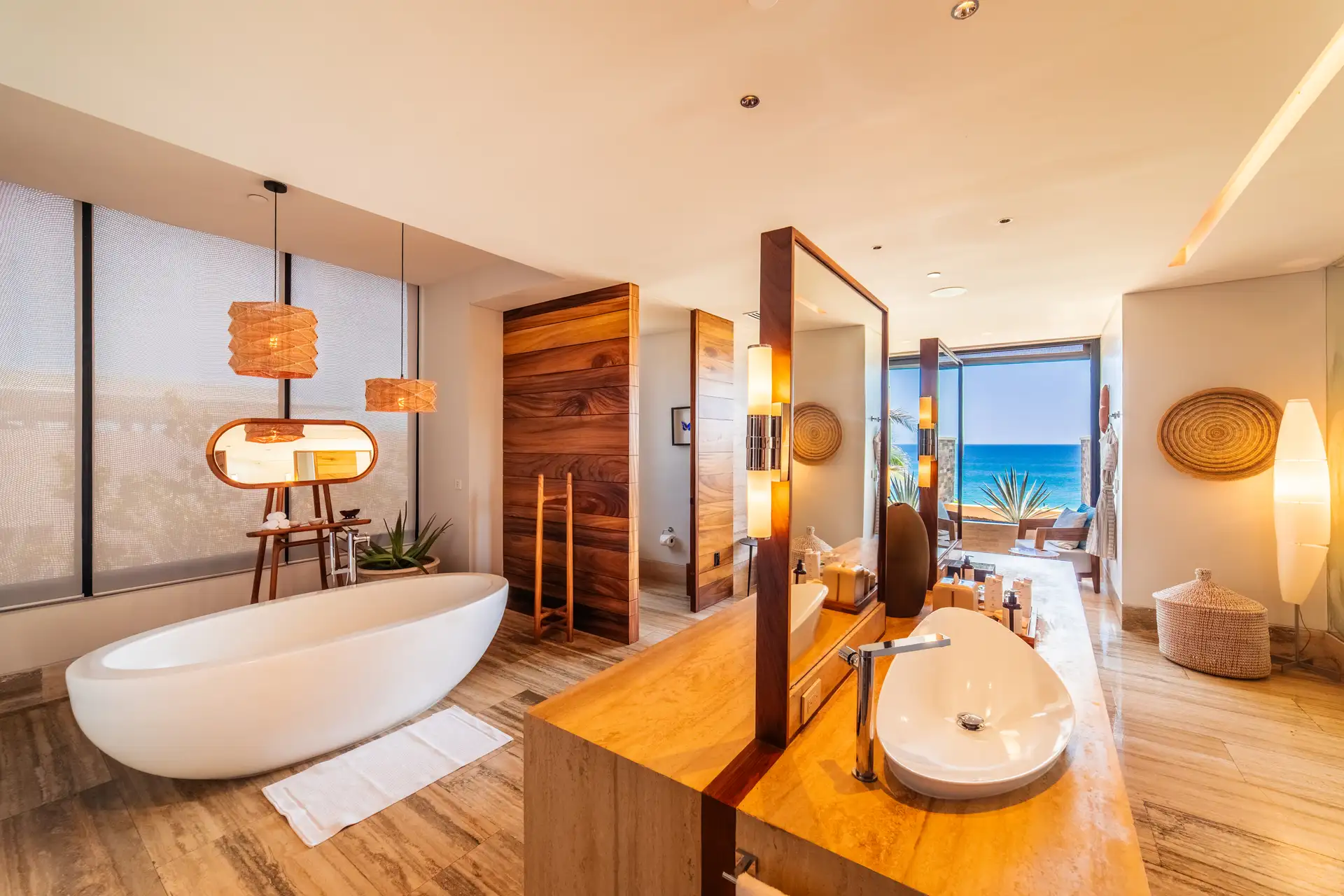Spa-inspired primary bathroom with a freestanding soaking tub and a separate wood vanity.